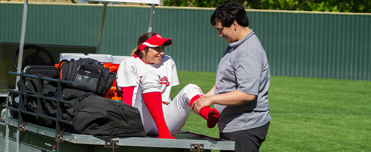 Athletic trainer assisting